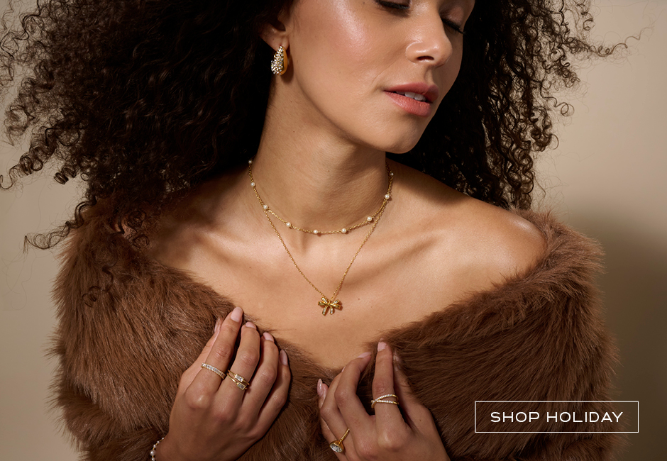 Woman wearing holiday inspired golden bow jewelry