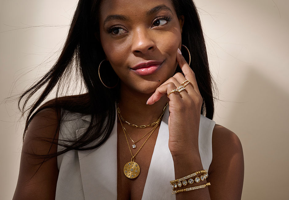 Woman wearing gold layered necklaces